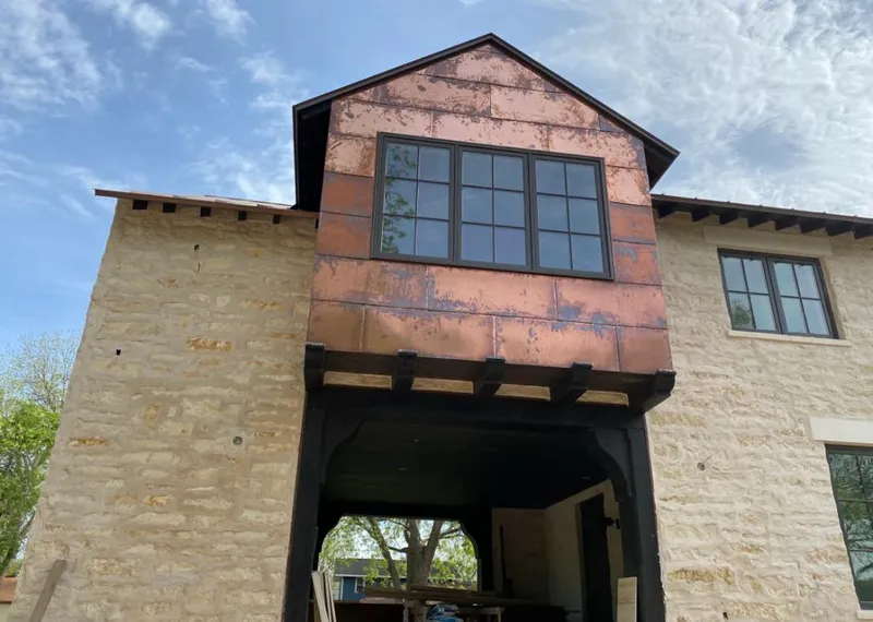 Copper metal panel facade on a stone building for Skylight Installation in Fort Bragg